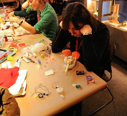 Ward tinkering with the gear box of a mechanical chicken, courtesy Asia Ward