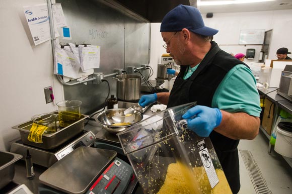 Beeswax is weighed out for a muscle salve created at Dixie Elixirs.