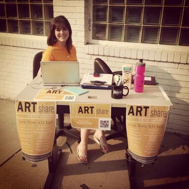 An intern at the Artshare table, courtesy Southern
