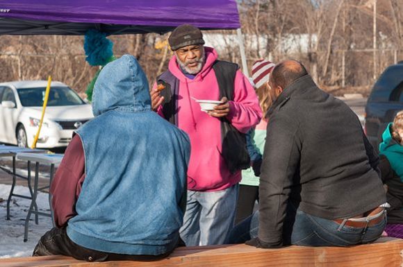 Melvin Giles, an organizer with Friendly Streets, greets Rondo neighbors
